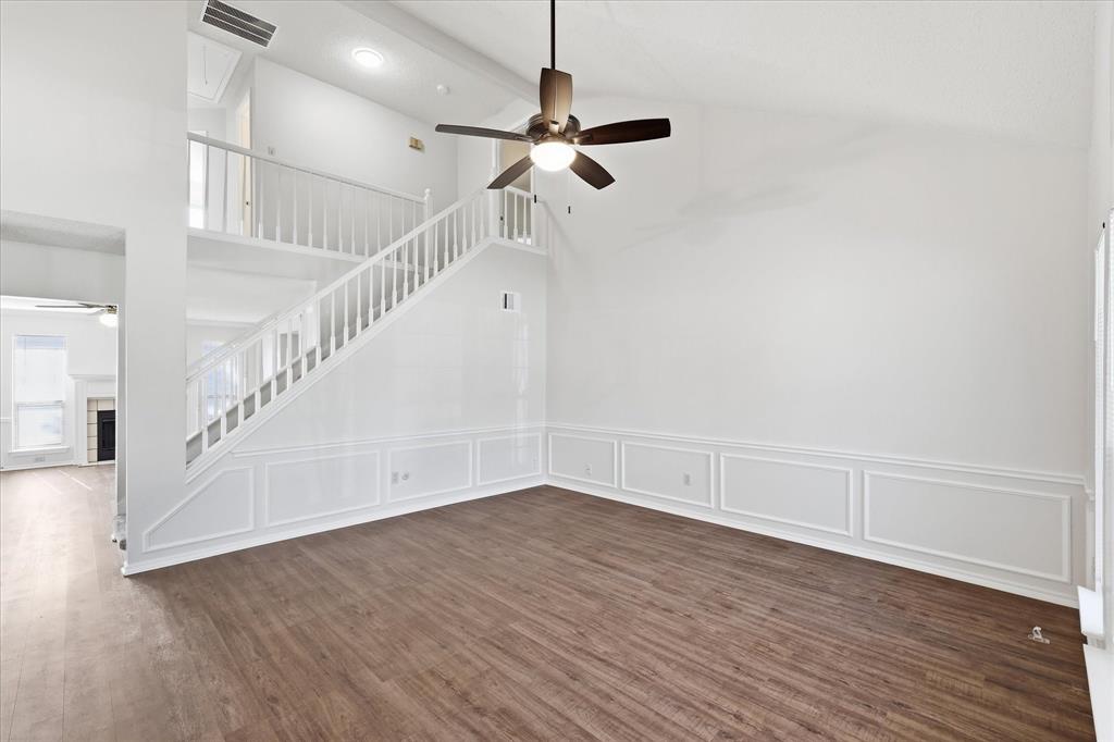 318 Lodge Road Coppell, TX 75019 - Photo 9 of 35 A light-filled living area with vaulted ceilings, expansive windows and plenty of room to create a comfortable everyday retreat.
