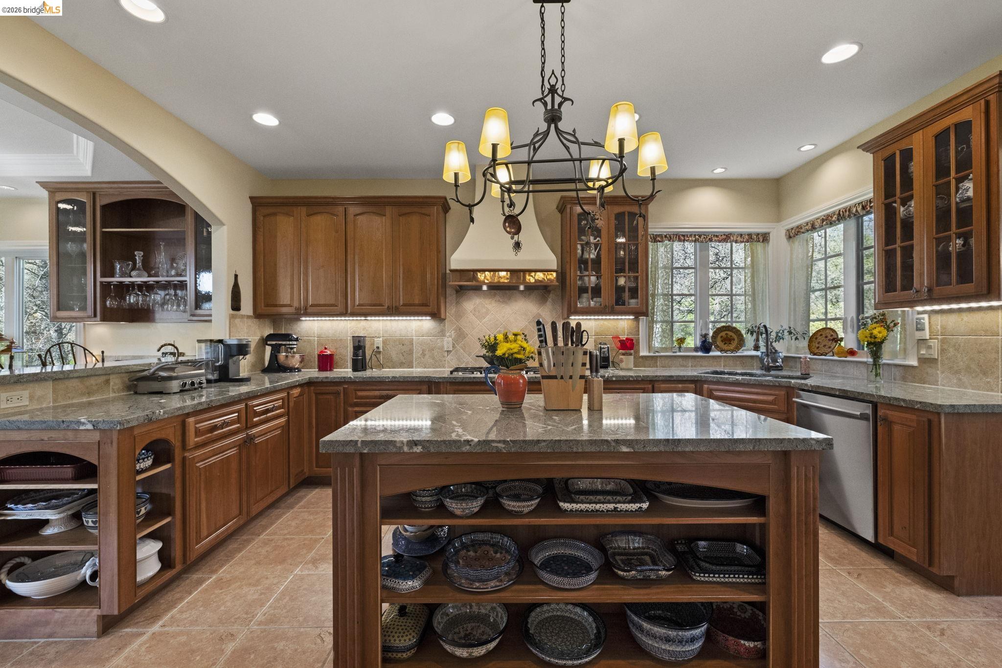 18558 Olov Road Sonora, CA 95370 - Photo 16 of 45 a kitchen with stainless steel appliances granite countertop a sink stove and cabinets