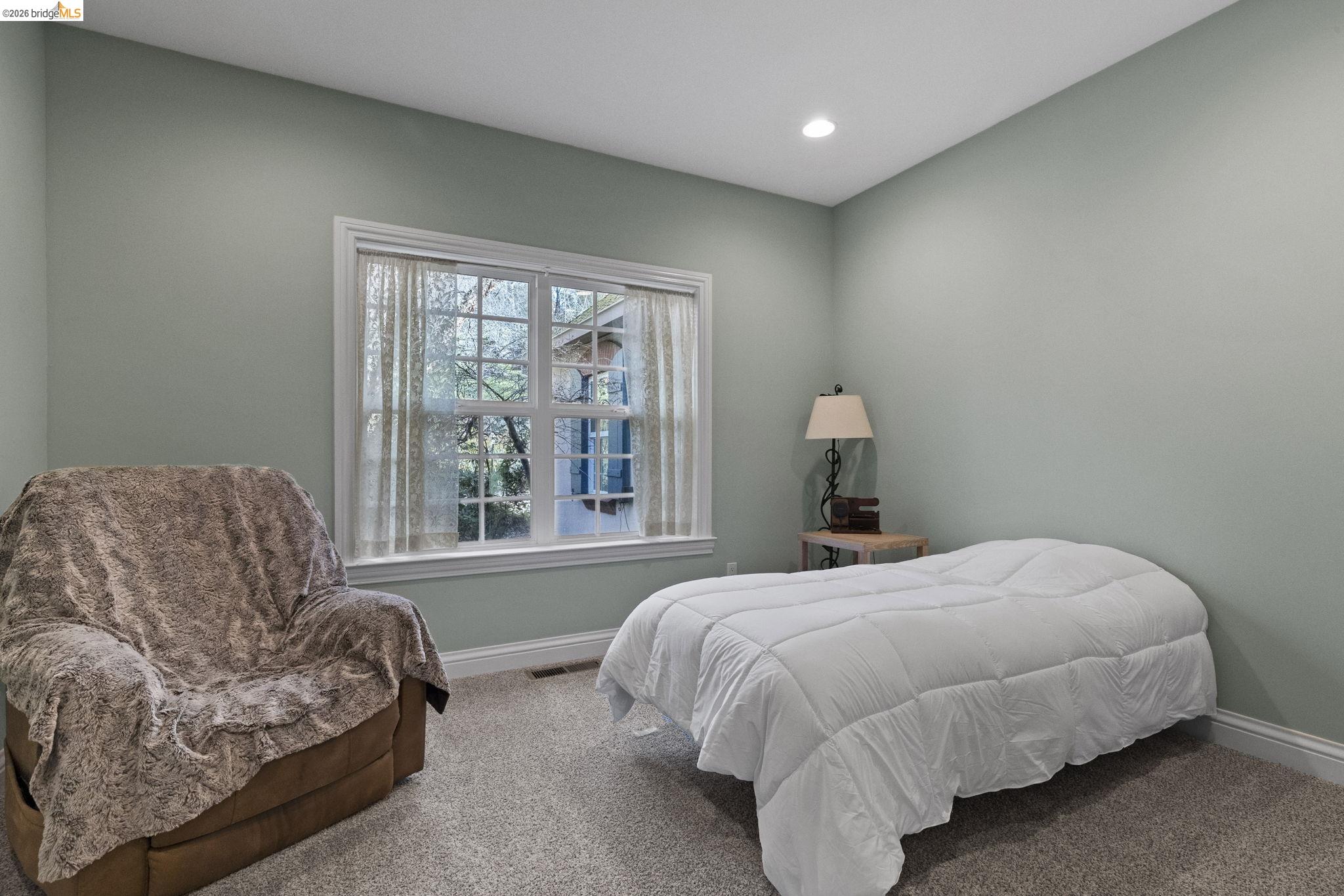 18558 Olov Road Sonora, CA 95370 - Photo 29 of 45 a bedroom with a bed couch and window