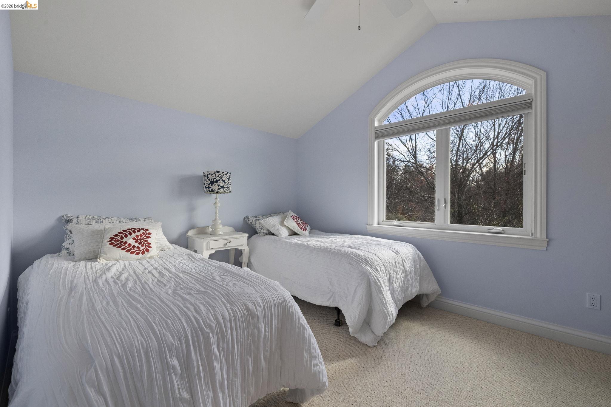 18558 Olov Road Sonora, CA 95370 - Photo 31 of 45 a bedroom with two beds and a large window