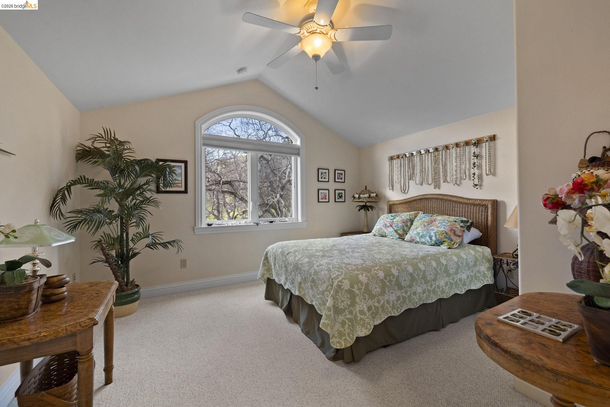 18558 Olov Road Sonora, CA 95370 - Photo 33 of 45 a bedroom with a bed and a chandelier