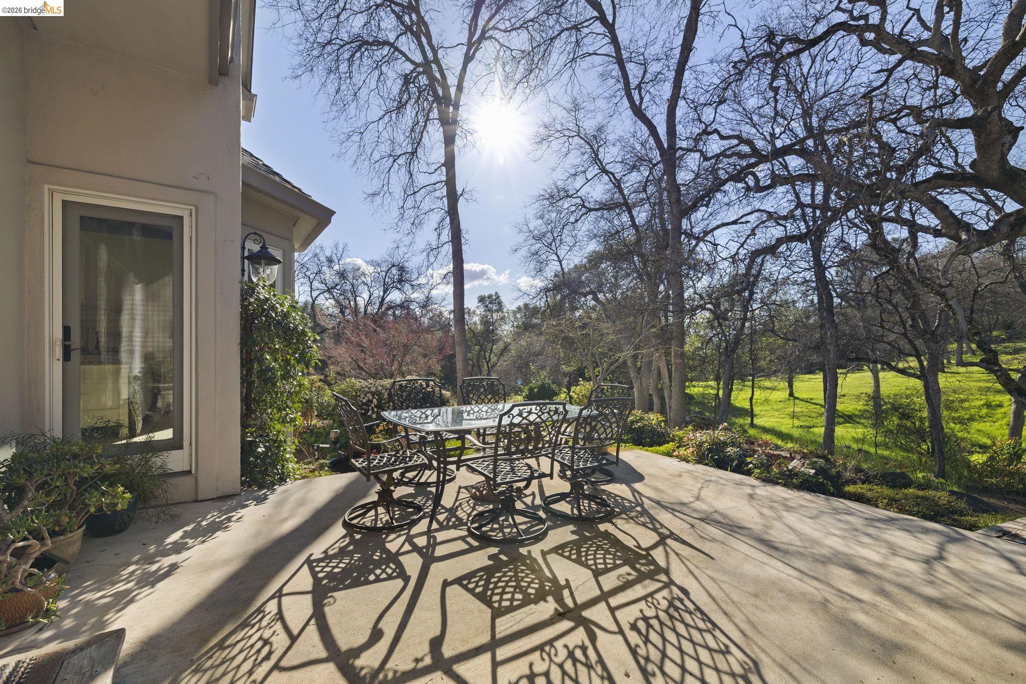 18558 Olov Road Sonora, CA 95370 - Photo 36 of 45 a view of a patio with table and chairs potted plants and large tree
