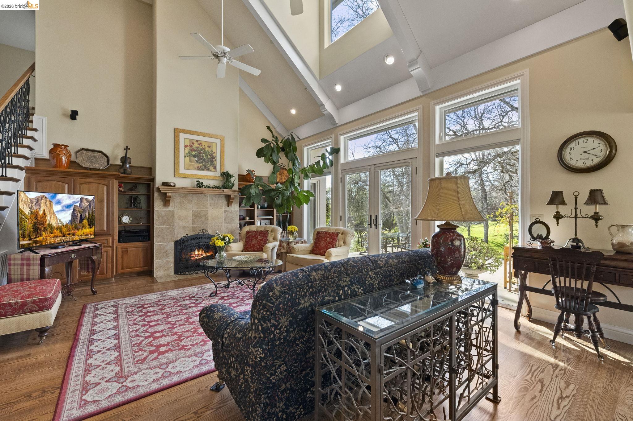18558 Olov Road Sonora, CA 95370 - Photo 9 of 45 a living room with furniture a flat screen tv and a floor to ceiling window