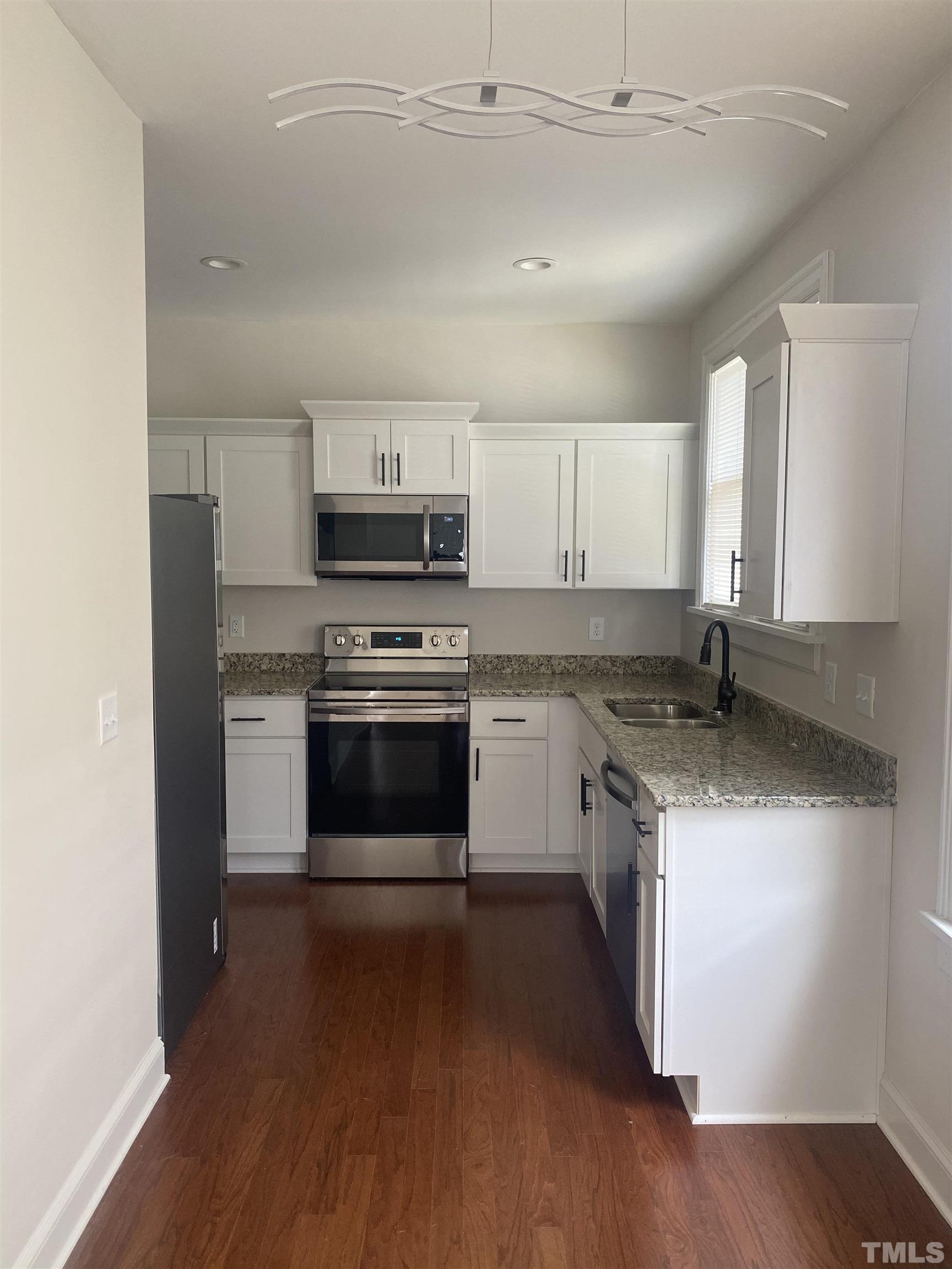 16 Turner Street Raleigh, NC 27607 - Photo 2 of 8 a kitchen with granite countertop a sink and steel appliances