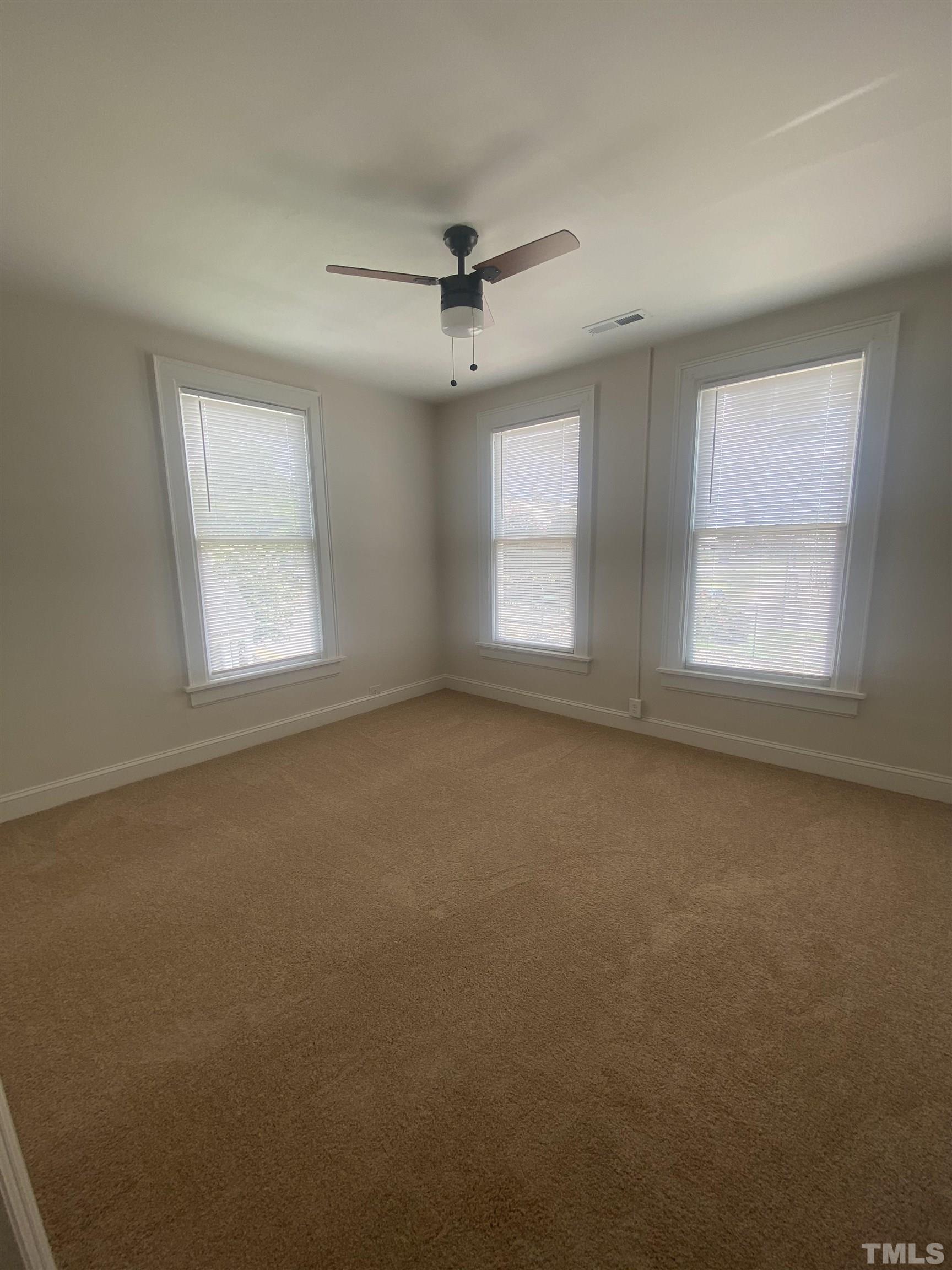16 Turner Street Raleigh, NC 27607 - Photo 7 of 8 an empty room with a window and fireplace