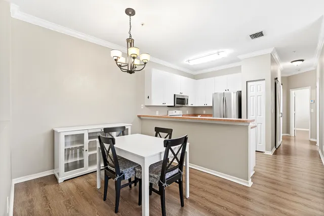 a view of a dining room with furniture wooden floor and chandelier
