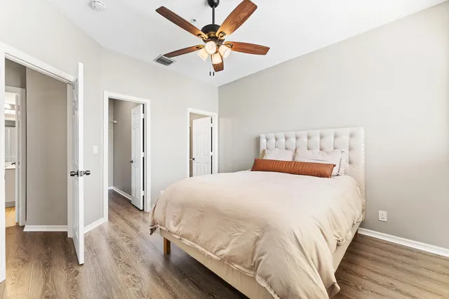 a bedroom with a bed and a ceiling fan