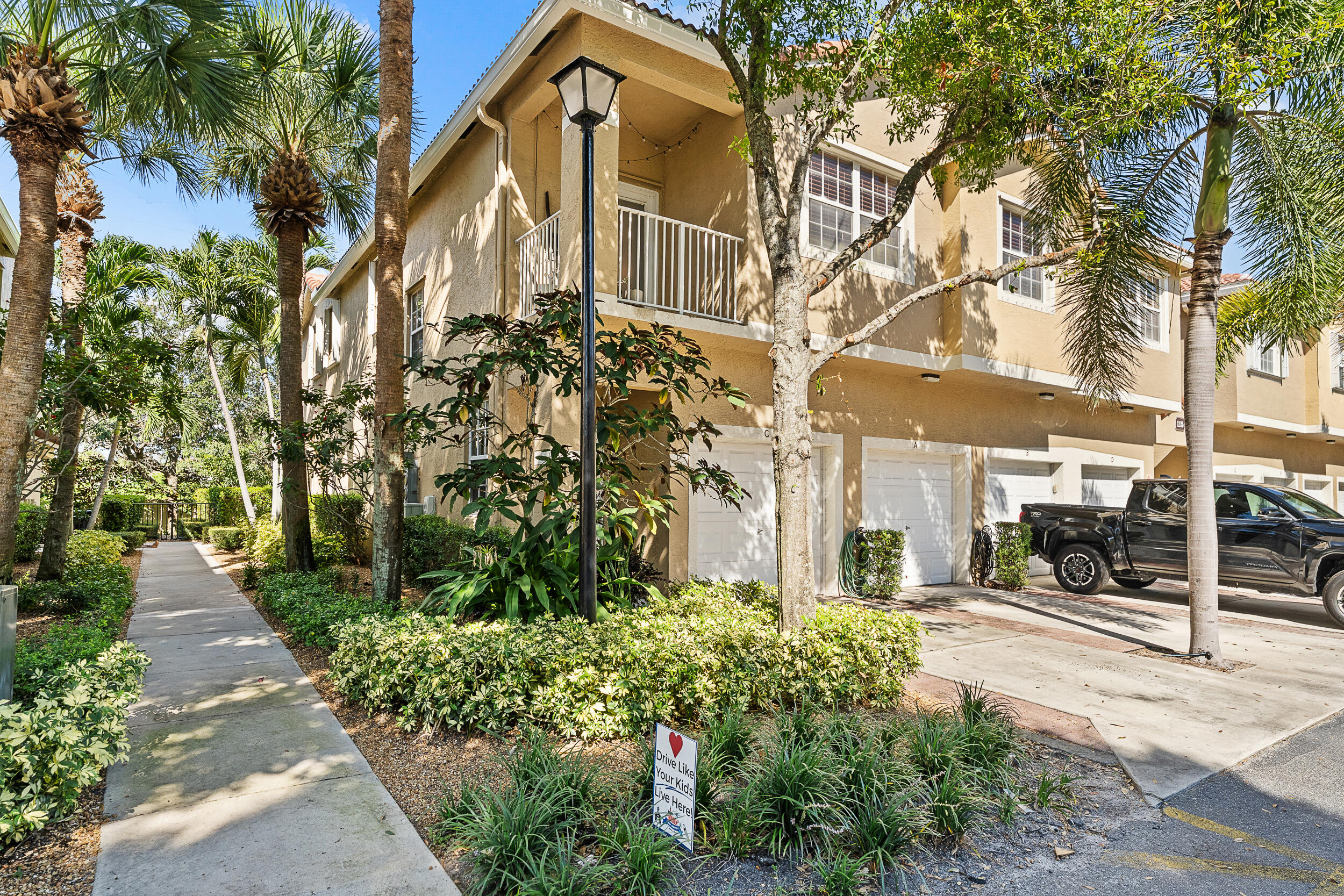 115 Lighthouse Circle, Unit C Tequesta, FL 33469 - Photo 6 of 29 a view of a building with a garden