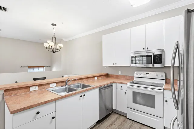 a kitchen with a sink stove and microwave