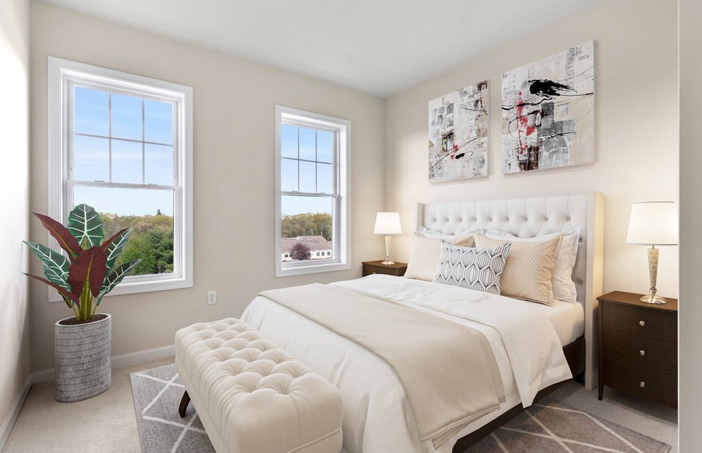 2 Stratton Drive, Unit 303 Woburn, MA 01801 - Photo 7 of 8 a bedroom with a bed and a painting on the wall