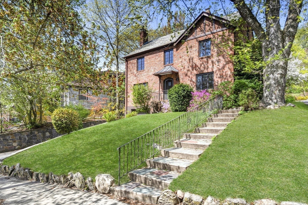 36 Blake Road Brookline, MA 02445 - Photo 1 of 34 a front view of a house with a yard and potted plants
