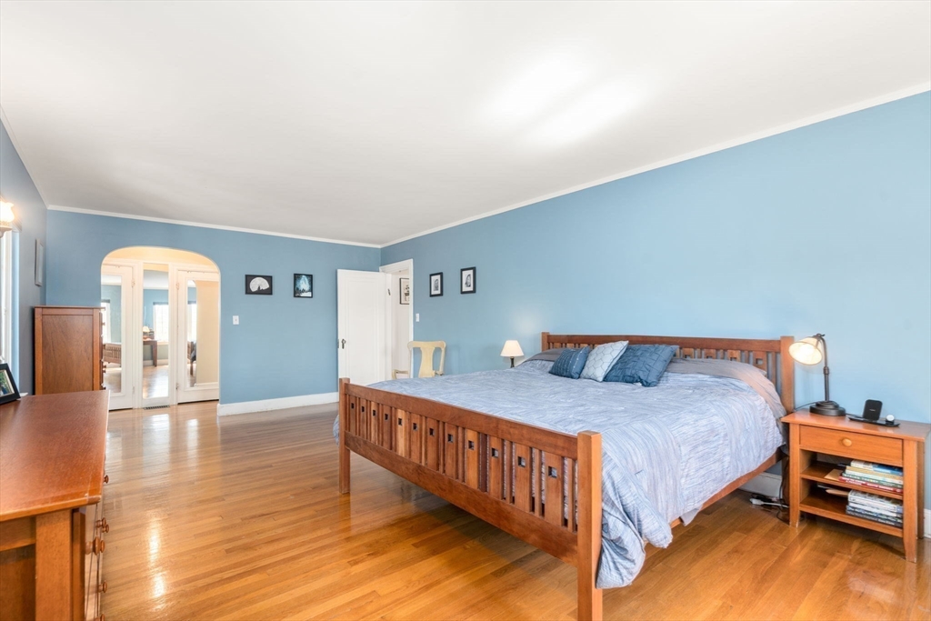 36 Blake Road Brookline, MA 02445 - Photo 22 of 34 a bedroom with a bed and wooden floor