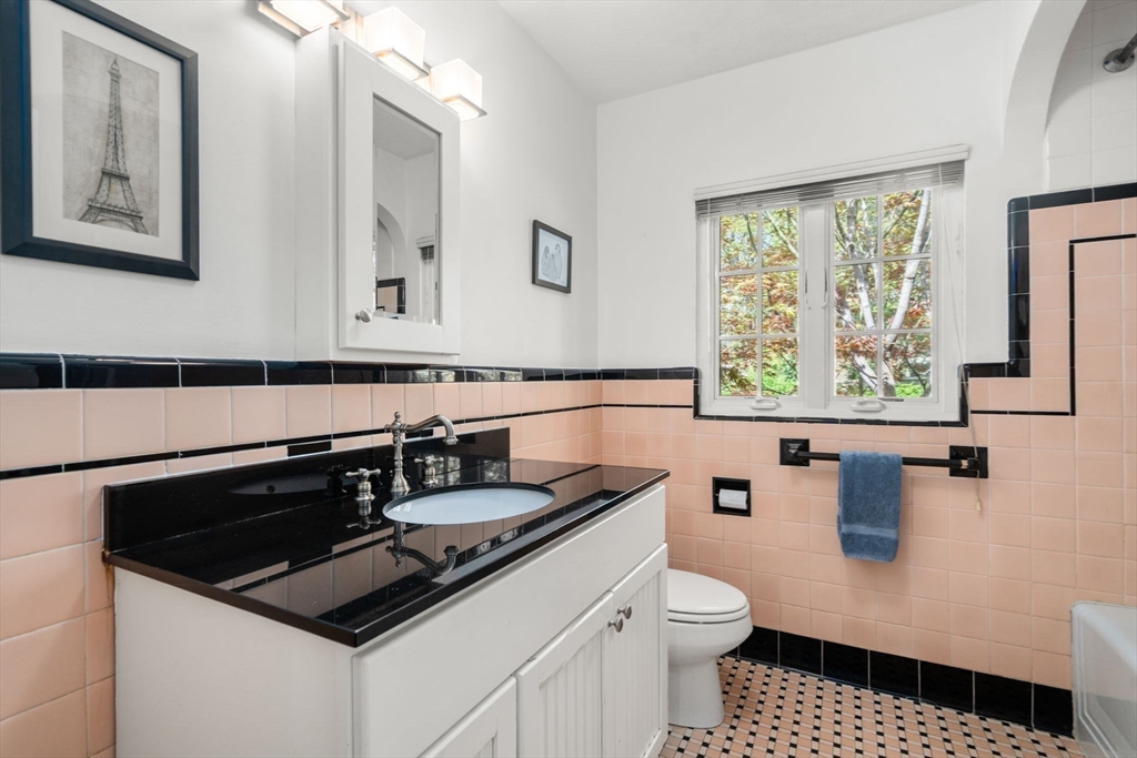 36 Blake Road Brookline, MA 02445 - Photo 24 of 34 a bathroom with a sink a toilet and a window