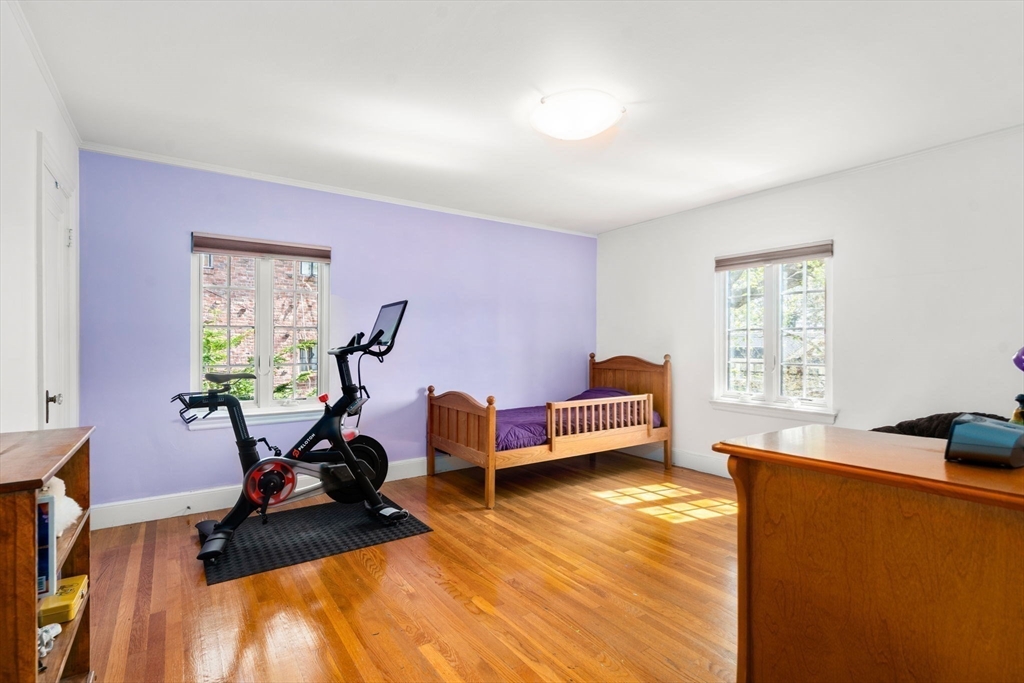 36 Blake Road Brookline, MA 02445 - Photo 27 of 34 a living room with furniture gym equipment and a window