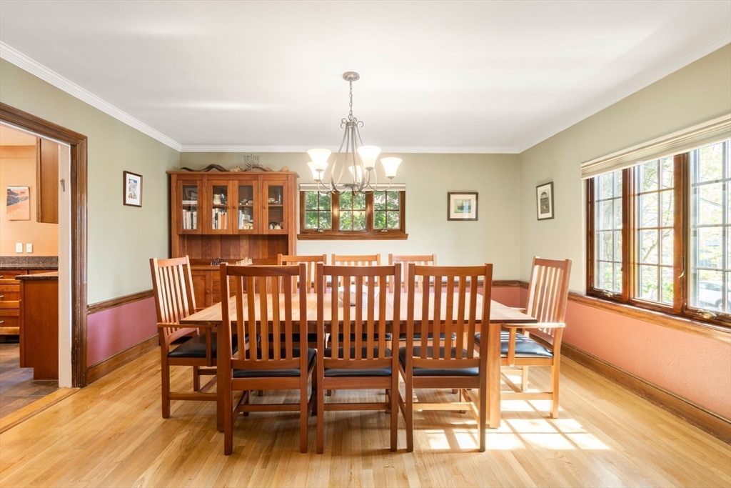 36 Blake Road Brookline, MA 02445 - Photo 4 of 34 a dining room with furniture a chandelier and wooden floor