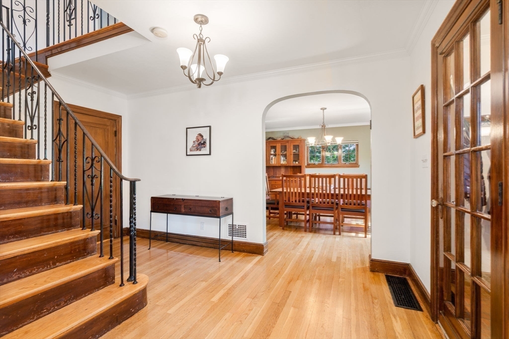 36 Blake Road Brookline, MA 02445 - Photo 9 of 34 a view of a livingroom with wooden floor and stairs