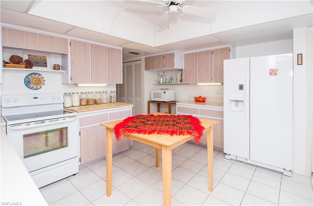 330 Kon Tiki Drive, Unit A2 Naples, FL 34113 - Photo 11 of 19 a kitchen with a sink cabinets and stainless steel appliances