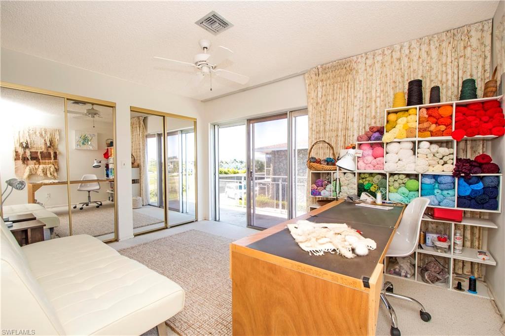 330 Kon Tiki Drive, Unit A2 Naples, FL 34113 - Photo 13 of 19 a living room with furniture and a chandelier