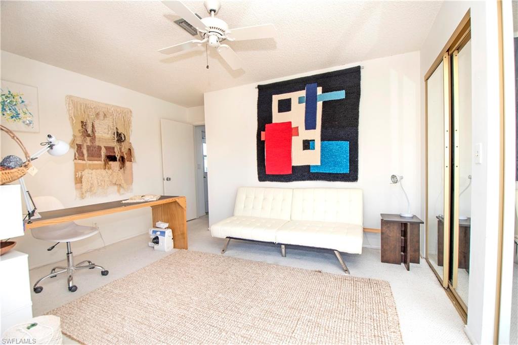 330 Kon Tiki Drive, Unit A2 Naples, FL 34113 - Photo 14 of 19 a bedroom with a bed and a window