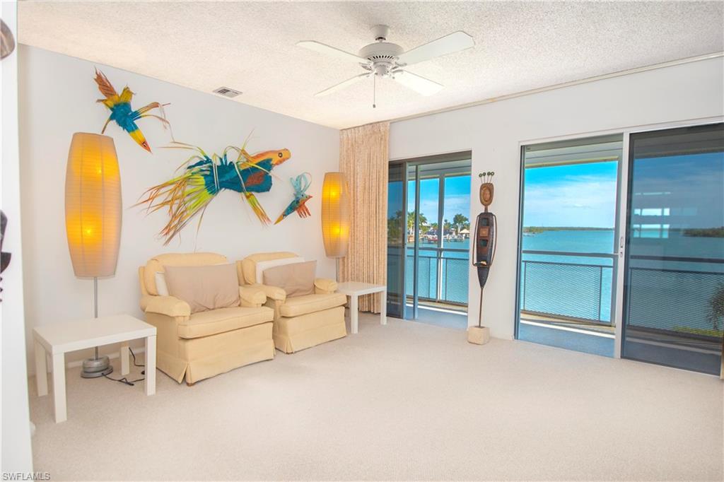 330 Kon Tiki Drive, Unit A2 Naples, FL 34113 - Photo 3 of 19 a living room with furniture and a table