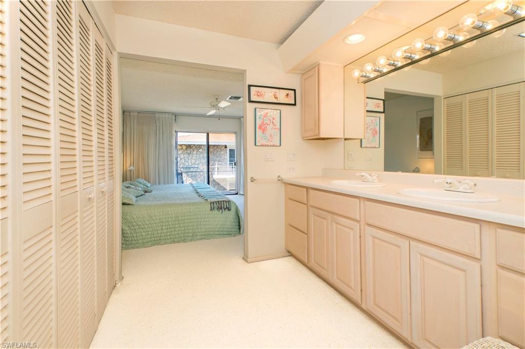 330 Kon Tiki Drive, Unit A2 Naples, FL 34113 - Photo 10 of 19 a spacious bathroom with a sink a mirror and a bathtub