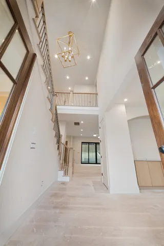 a living room with a large fireplace and large windows