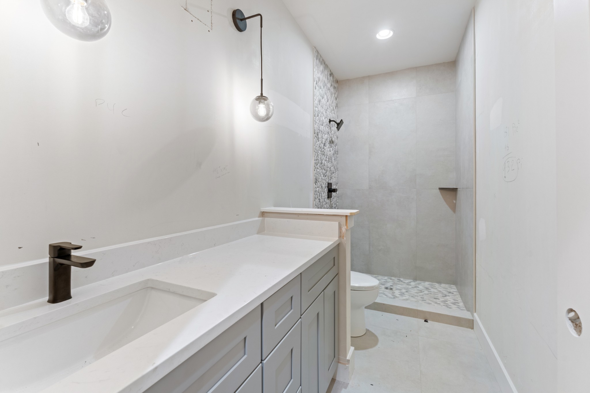 7678 Sawyer Brown Road Nashville, TN 37209 - Photo 61 of 77 a bathroom with a sink a toilet and shower