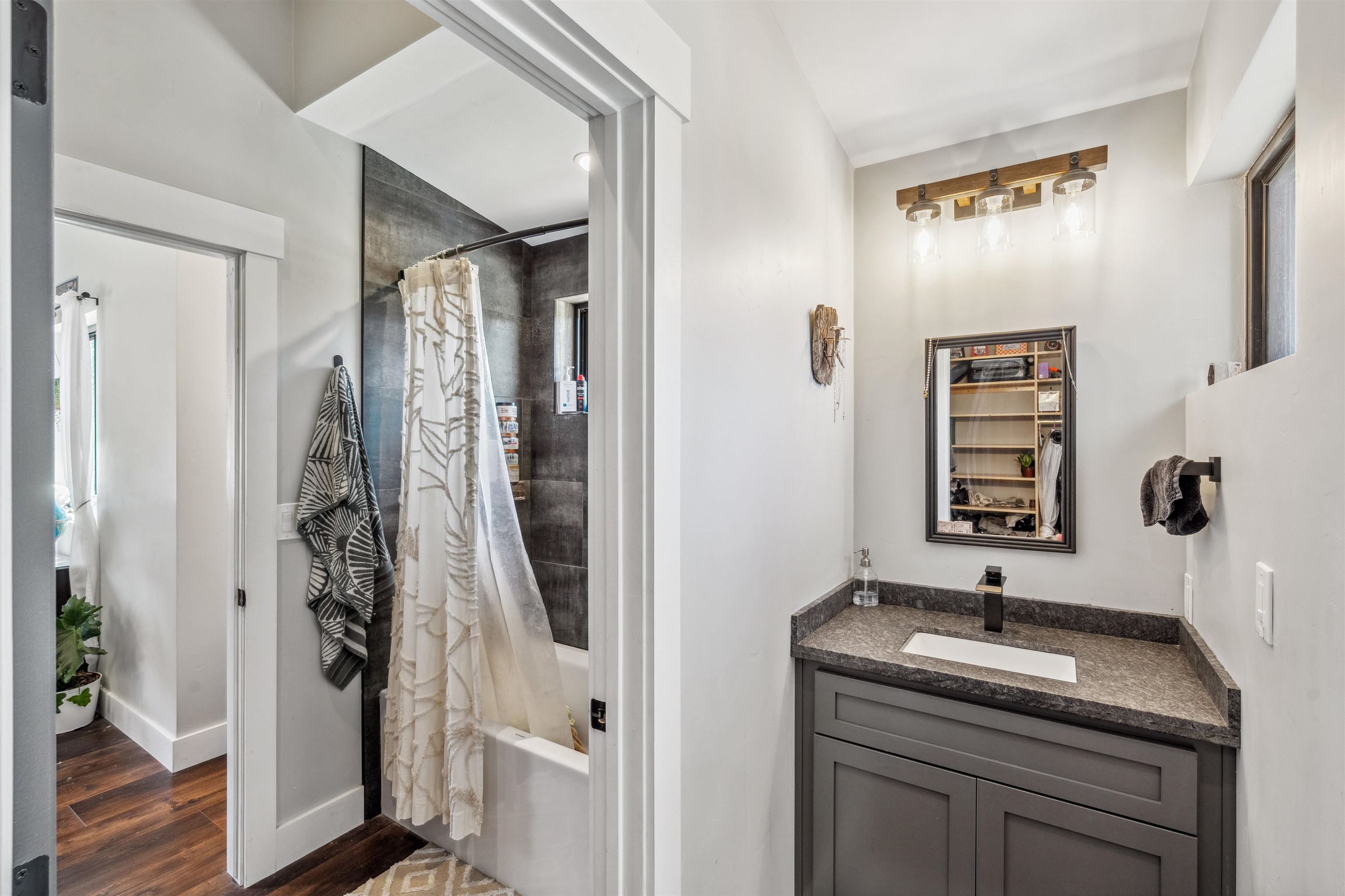 134 Smithneck Road Loyalton, CA 96118 - Photo 16 of 26 a bathroom with a granite countertop sink a mirror and shower