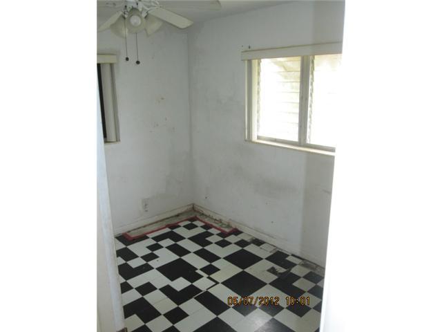1060 West 3rd Street Riviera Beach, FL 33404 - Photo 8 of 10 a bathroom with a black and white checkered floor