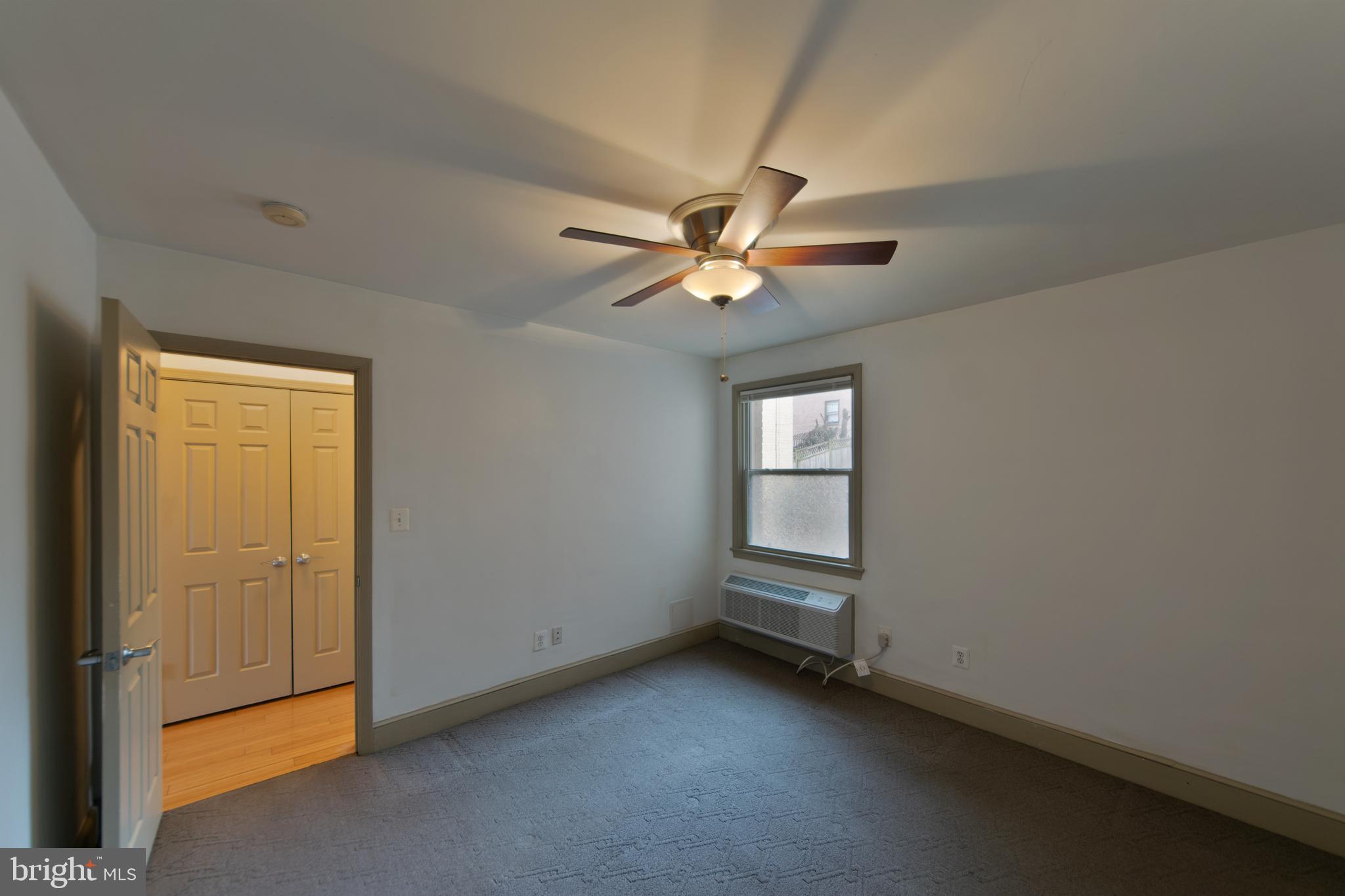 1363 K Street Southeast, Unit 103 Washington, DC 20003 - Photo 11 of 19 an empty room with windows and fan