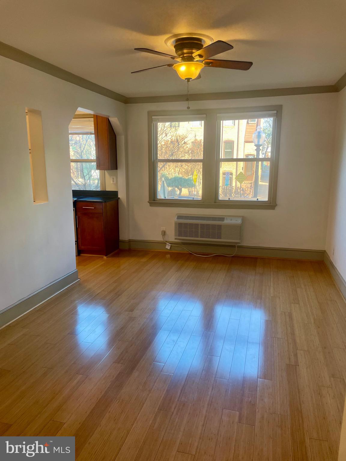 1363 K Street Southeast, Unit 103 Washington, DC 20003 - Photo 6 of 14 an empty room with wooden floor and windows
