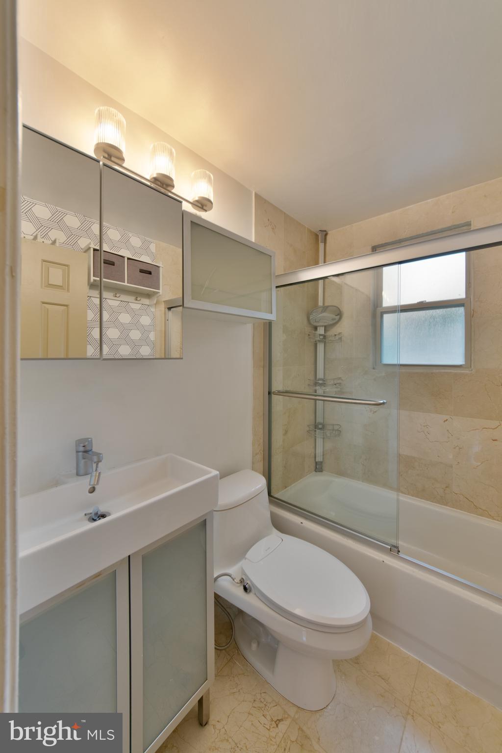 1363 K Street Southeast, Unit 103 Washington, DC 20003 - Photo 8 of 19 a bathroom with a sink a toilet and shower