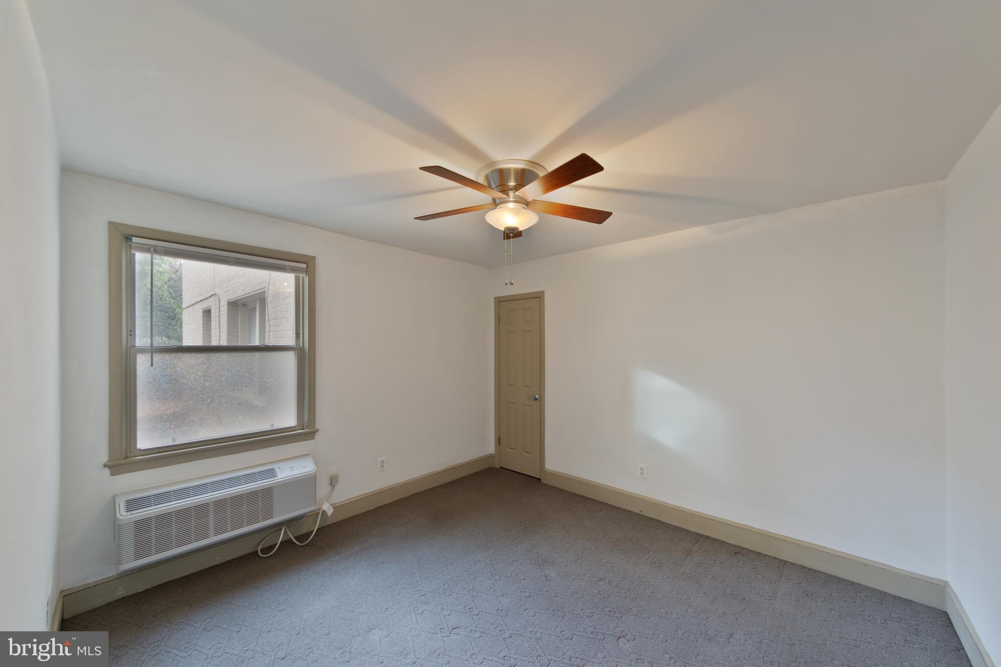 1363 K Street Southeast, Unit 103 Washington, DC 20003 - Photo 10 of 19 an empty room with windows and fan