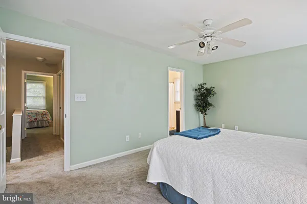 a bedroom with a large bed and chandelier