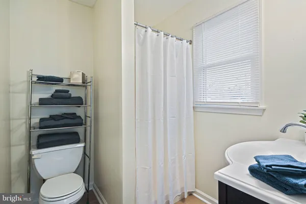 a bathroom with a toilet and a window