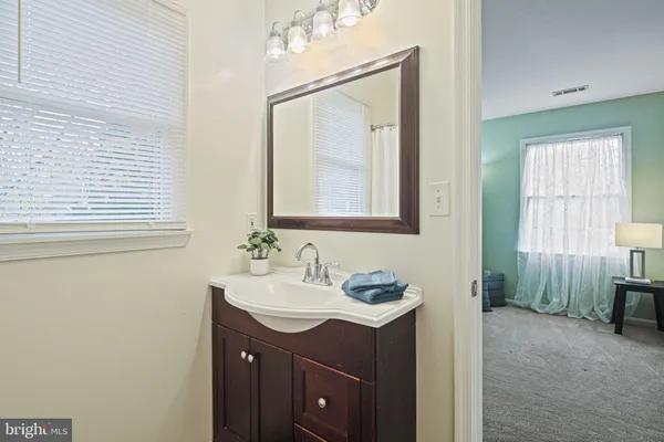 a bathroom with a sink vanity and mirror