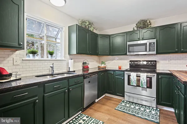 a kitchen with a sink stove and microwave