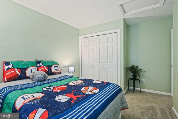 a bedroom with a bed and a dresser