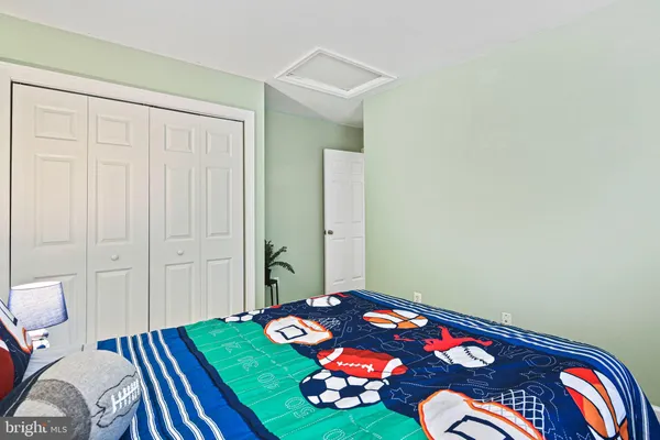 a bedroom with a bed and a lamp