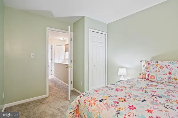 a bedroom with a bed and hallway