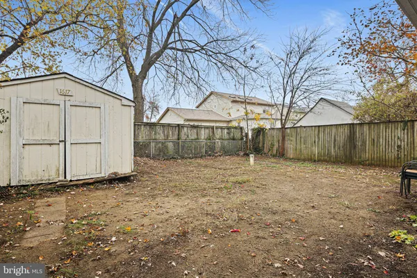 a backyard of a house with wooden fence