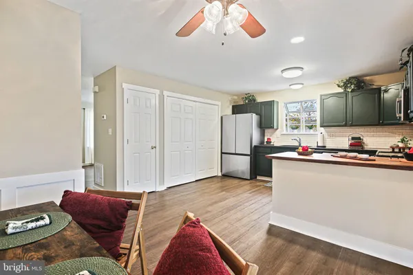 a living room with furniture and kitchen view