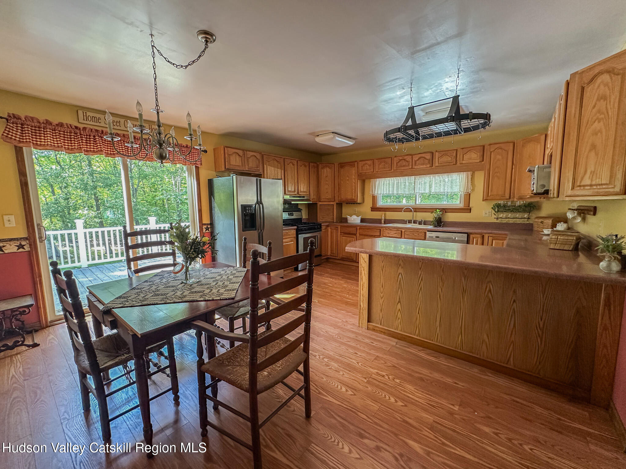 317 Scutt Road Greenville, NY 12083 - Photo 11 of 25 a view of a kitchen from a dining room with chairs