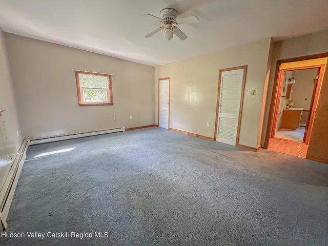 an empty room with windows and closet