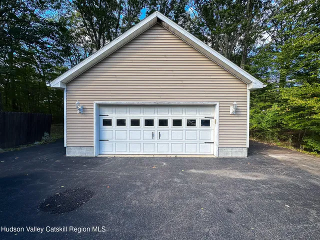 a view of a house with a yard and garage
