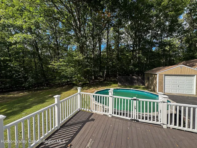 a view of balcony with wooden floor and fence