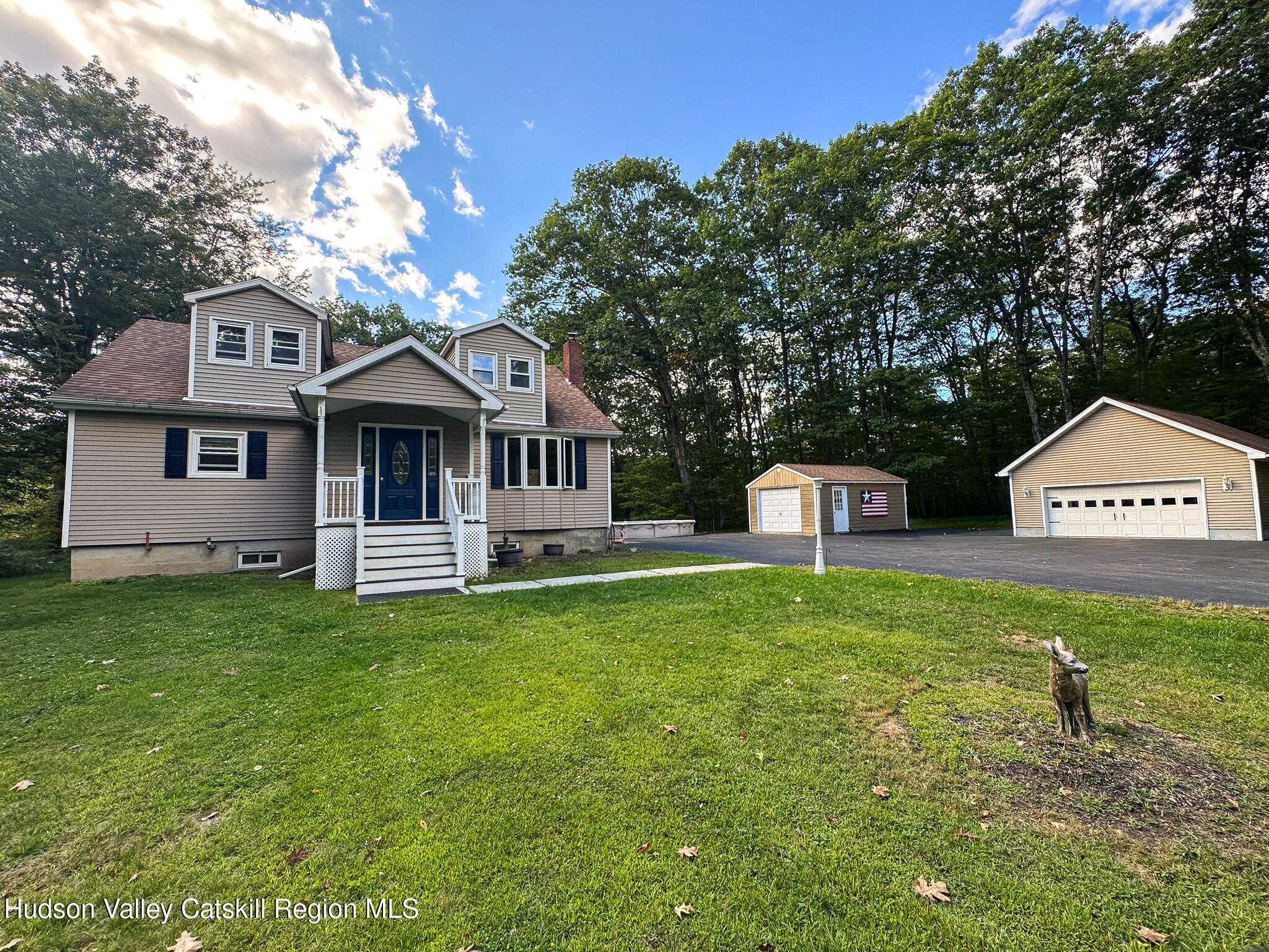 317 Scutt Road Greenville, NY 12083 - Photo 2 of 25 a front view of a house with a garden and trees