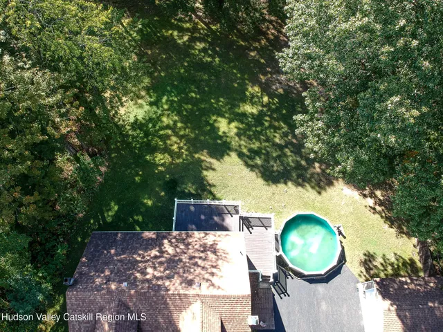a view of a backyard with table and chairs with wooden fence and plants