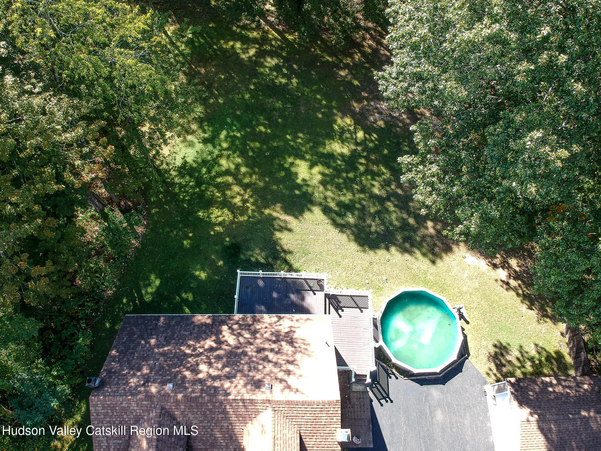 317 Scutt Road Greenville, NY 12083 - Photo 22 of 25 a view of a backyard with table and chairs with wooden fence and plants