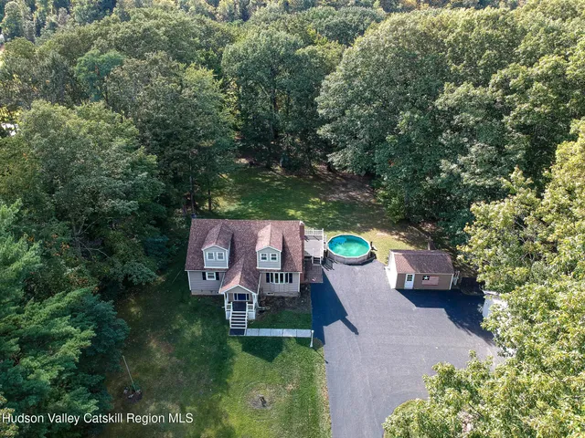 an aerial view of a house with outdoor space and sitting area